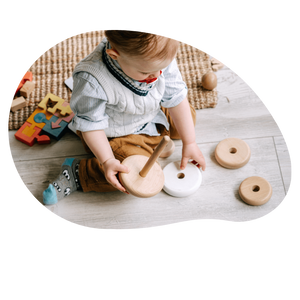 toddler playing with wooden toy